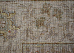 A close-up of an Afghan Chobi rug featuring intricate floral patterns in soft, earthy tones.