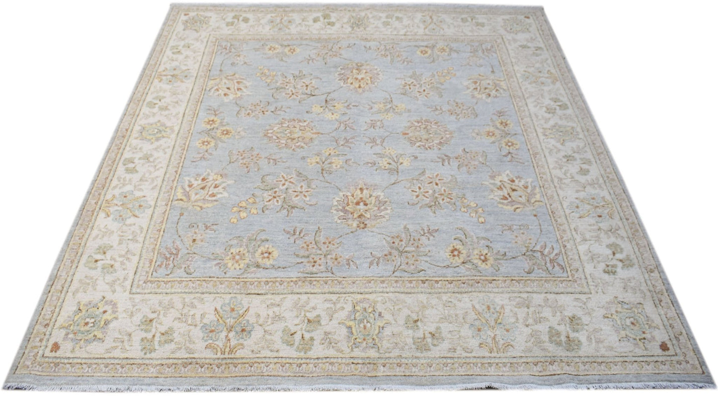 A square Afghan Chobi rug featuring a light blue field with a traditional floral pattern.