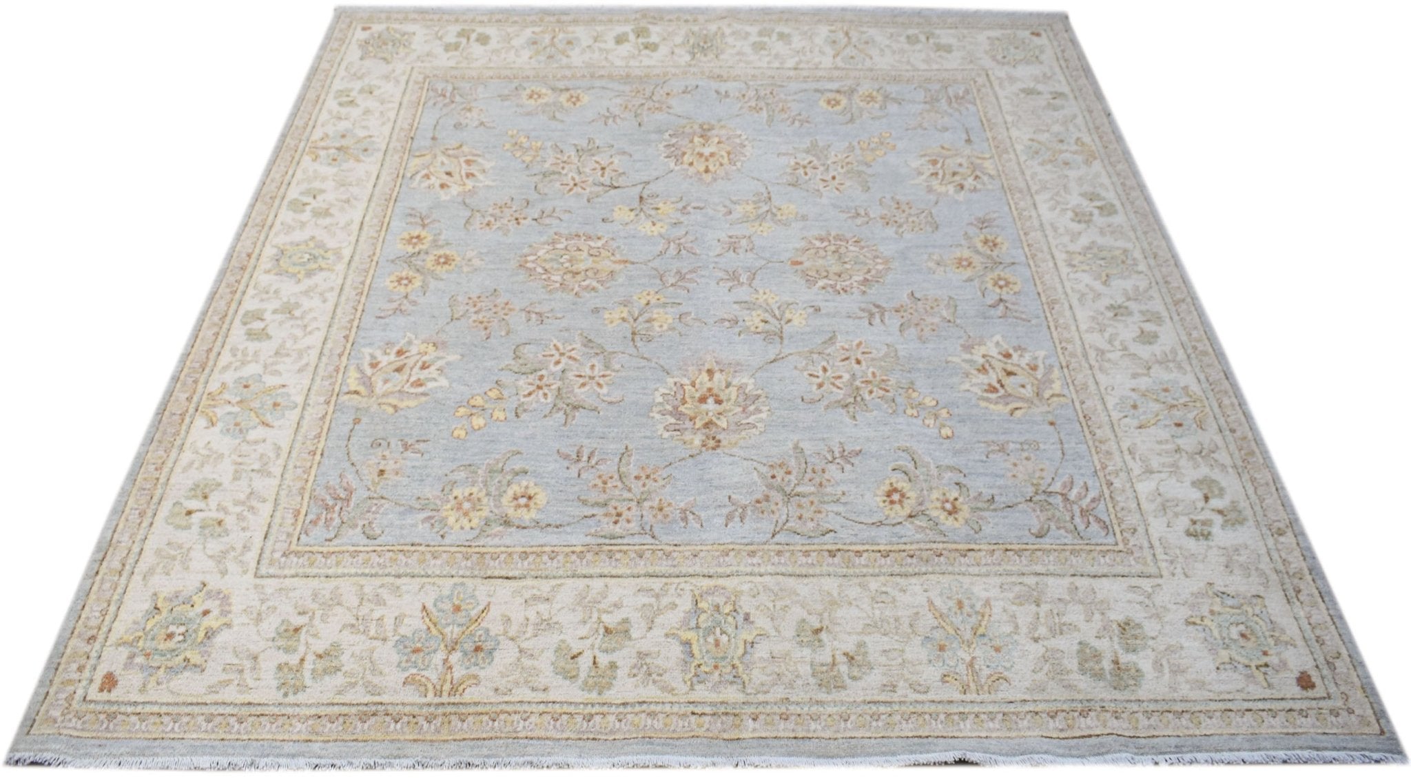A square Afghan Chobi rug featuring a light blue field with a traditional floral pattern.