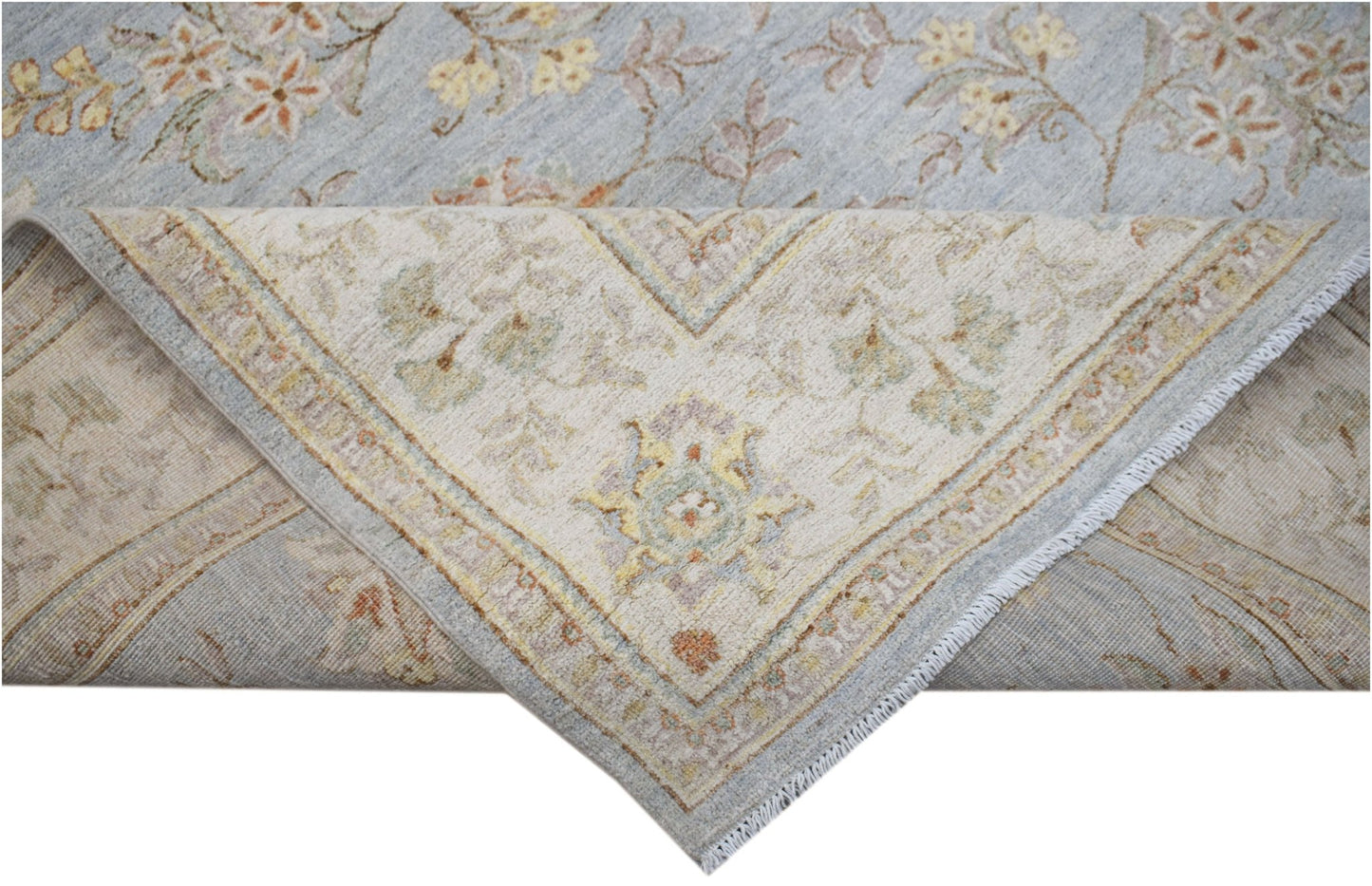 A handwoven Afghan Chobi rug featuring a light blue floral field and a cream-colored border.