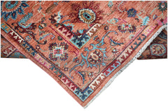 A handwoven Afghan Chobi rug featuring intricate floral patterns in shades of terracotta and blue.