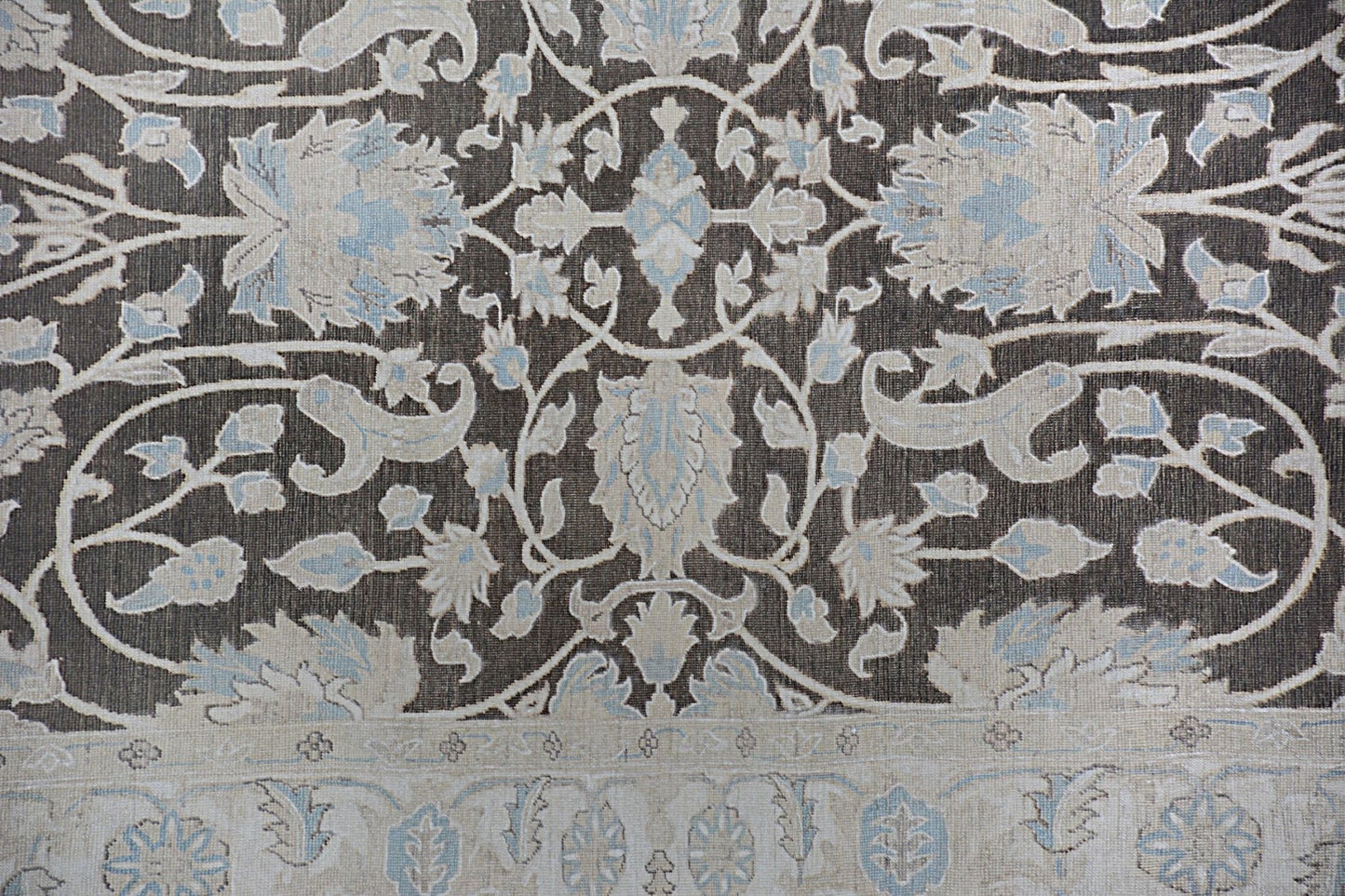 An Afghan Chobi rug featuring a traditional floral pattern in shades of brown, cream, and blue.
