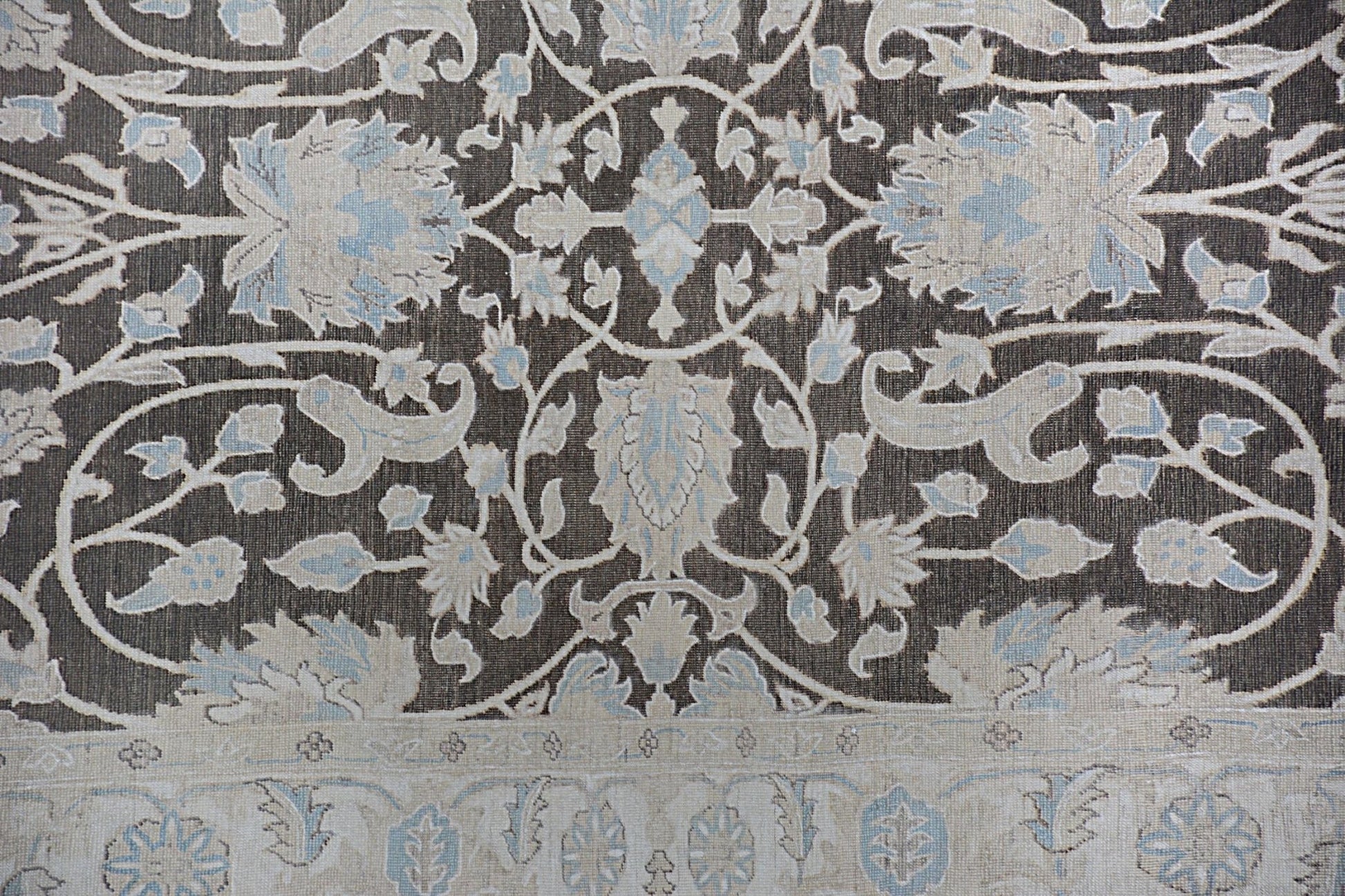 An Afghan Chobi rug featuring a traditional floral pattern in shades of brown, cream, and blue.