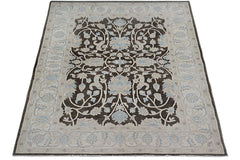 Handmade Afghan Chobi rug featuring a dark brown field with intricate light blue floral patterns.