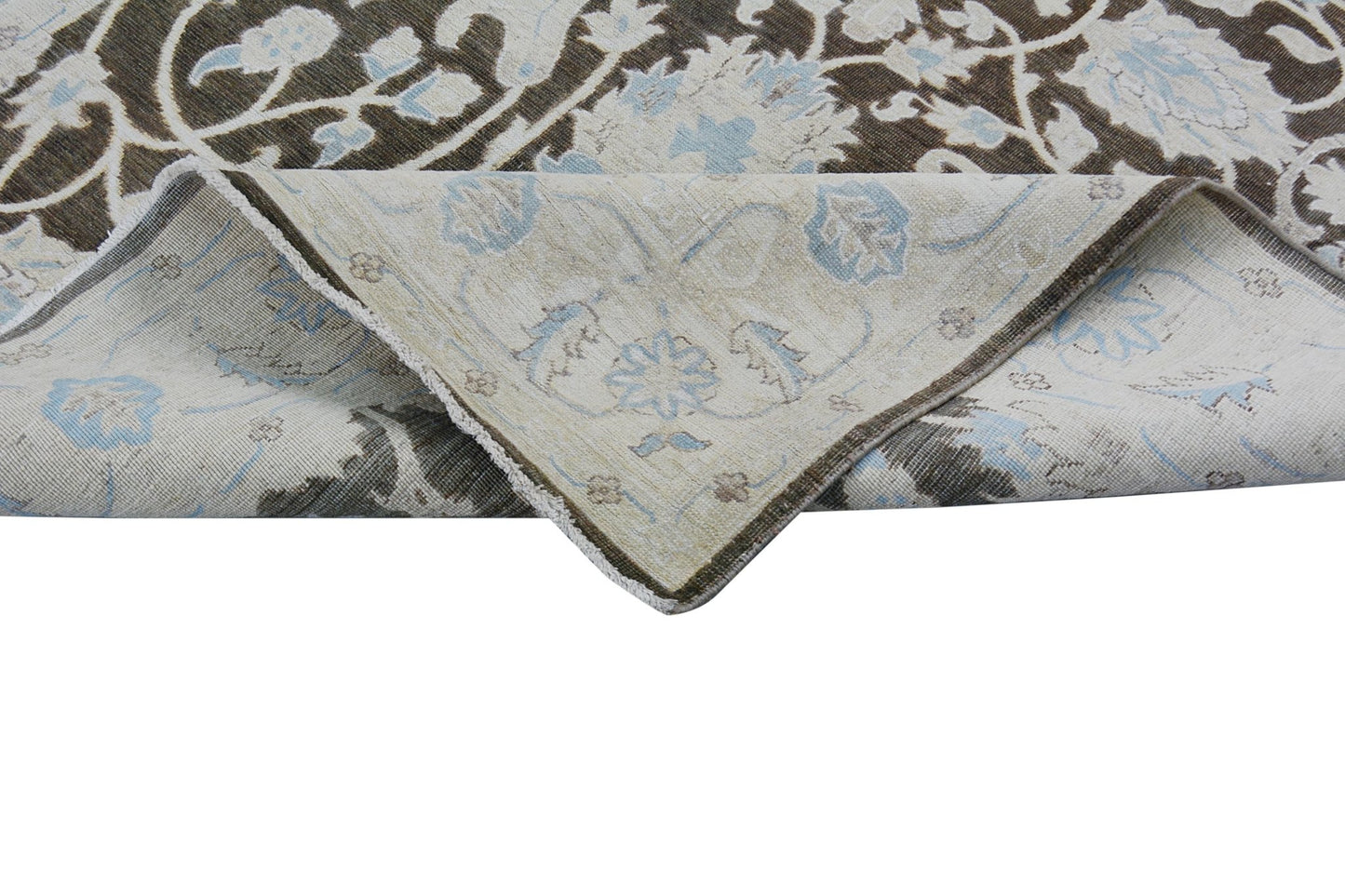 A handmade Afghan Chobi rug featuring a floral pattern in brown, cream, and light blue tones.