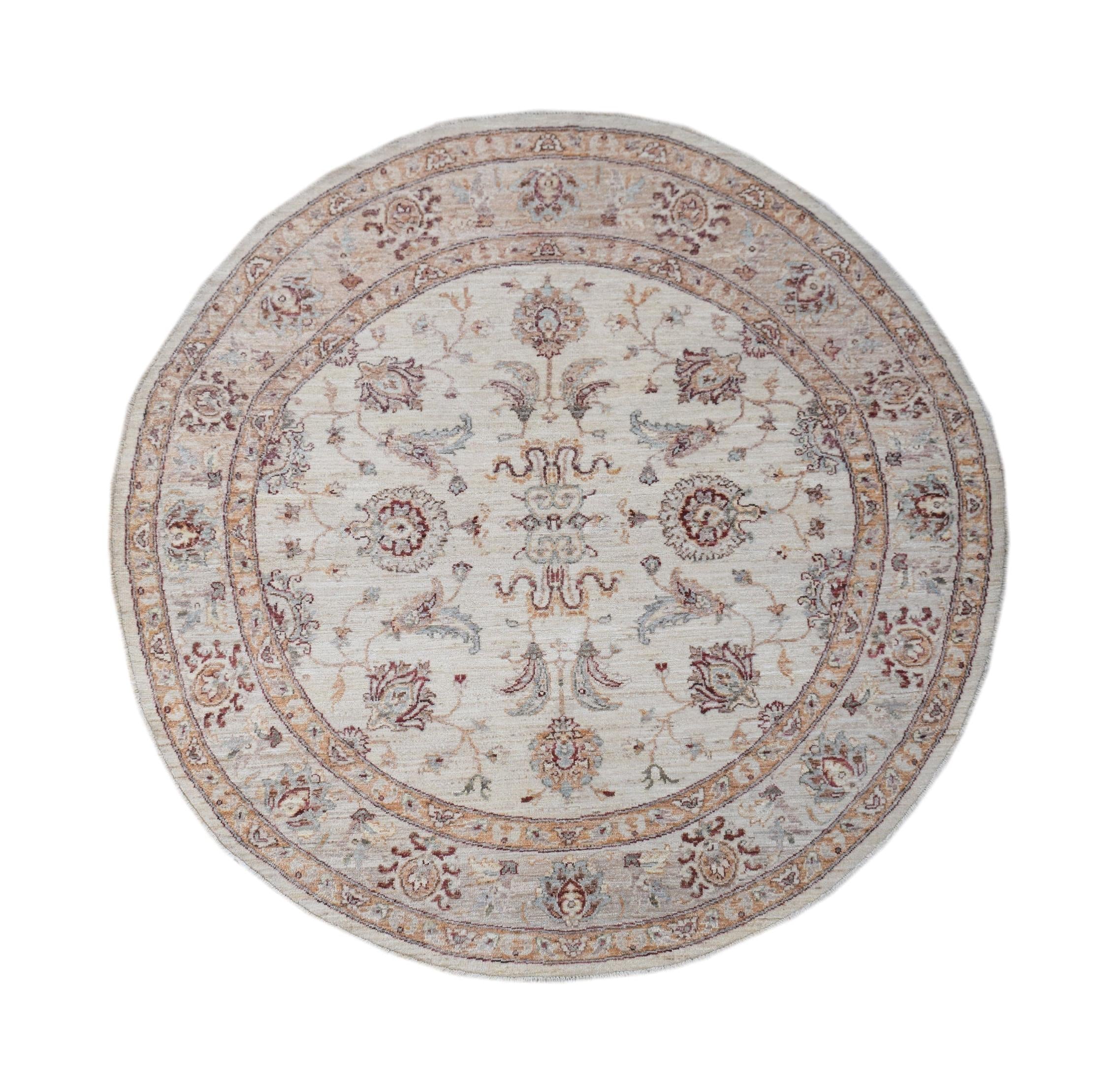 A round Afghan Chobi rug featuring a traditional floral pattern in soft, earthy tones.