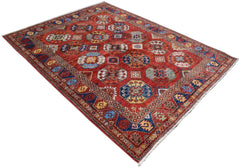 A handmade Afghan Chobi rug featuring a red field with repeating geometric octagonal motifs.