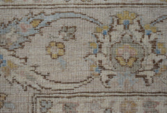 A close-up of an Afghan Chobi rug featuring intricate floral patterns in soft, earthy tones.