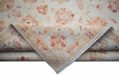 A handwoven Afghan Chobi rug featuring a traditional floral pattern in soft orange and cream tones.