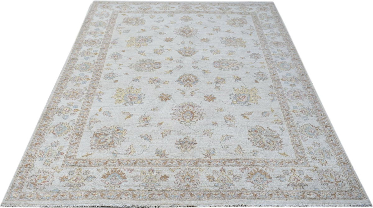 A rectangular Afghan Chobi rug featuring a traditional floral pattern in soft, earthy tones.