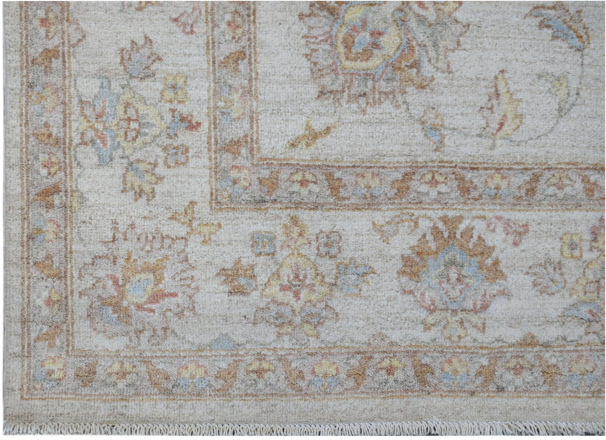 A handmade Afghan Chobi rug featuring a traditional floral pattern in soft, earthy tones.