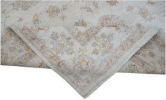 A handwoven Afghan Chobi rug featuring a traditional floral pattern in soft, earthy tones.