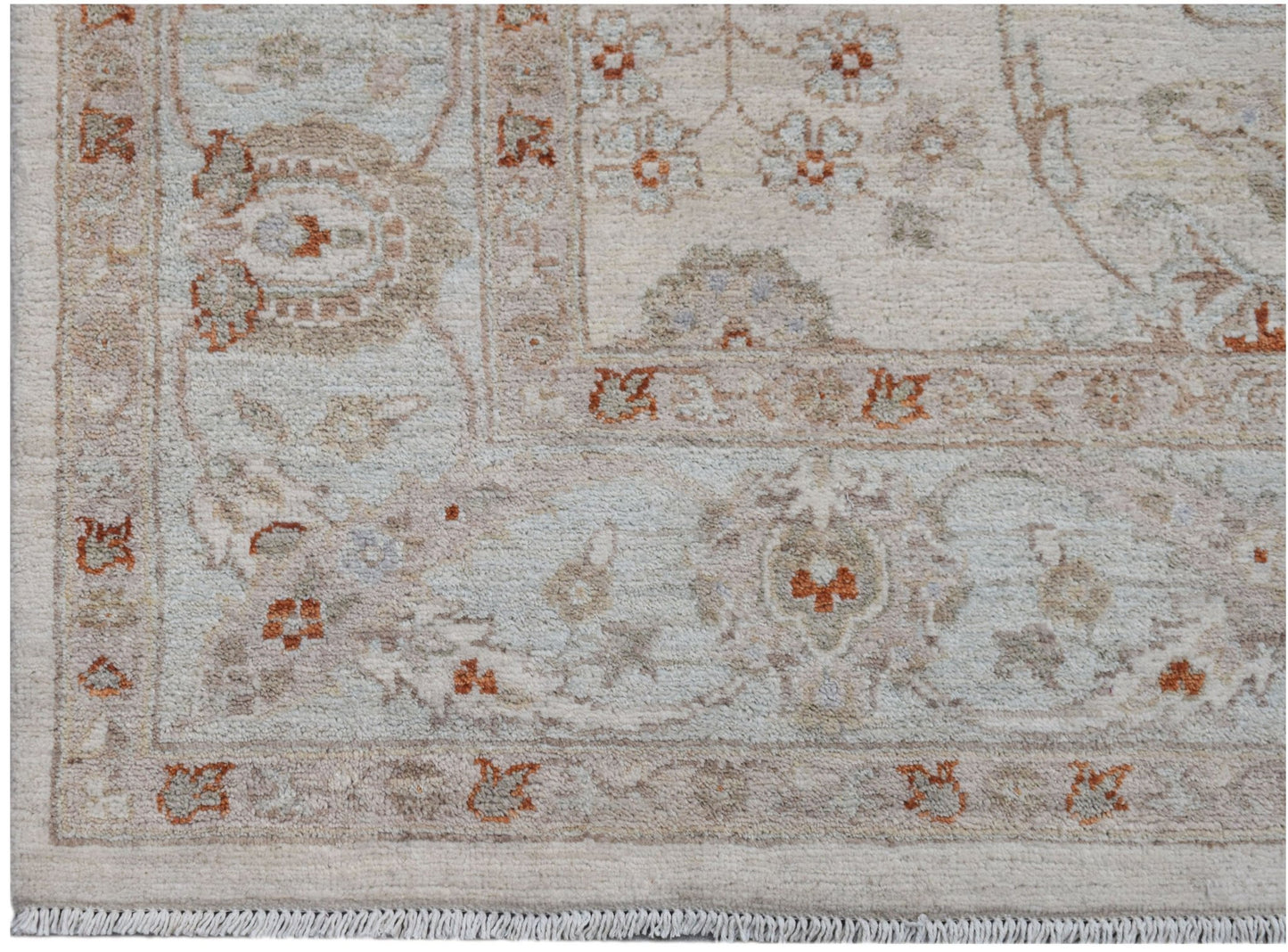 A handwoven Afghan Chobi rug featuring a traditional floral pattern in soft earth tones.
