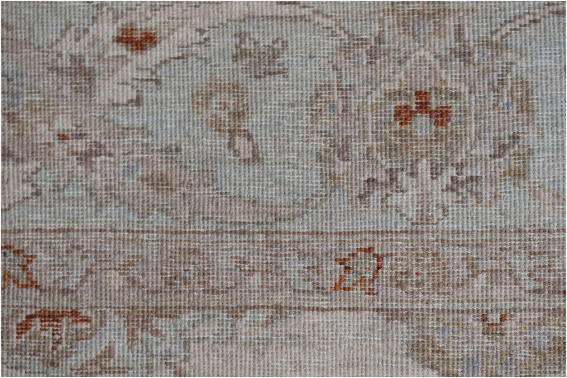 A close-up of a handwoven Afghan Chobi rug featuring traditional patterns in soft, earthy tones.