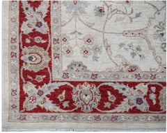 A handmade Afghan Chobi rug featuring a traditional floral pattern in red, beige, and blue tones.