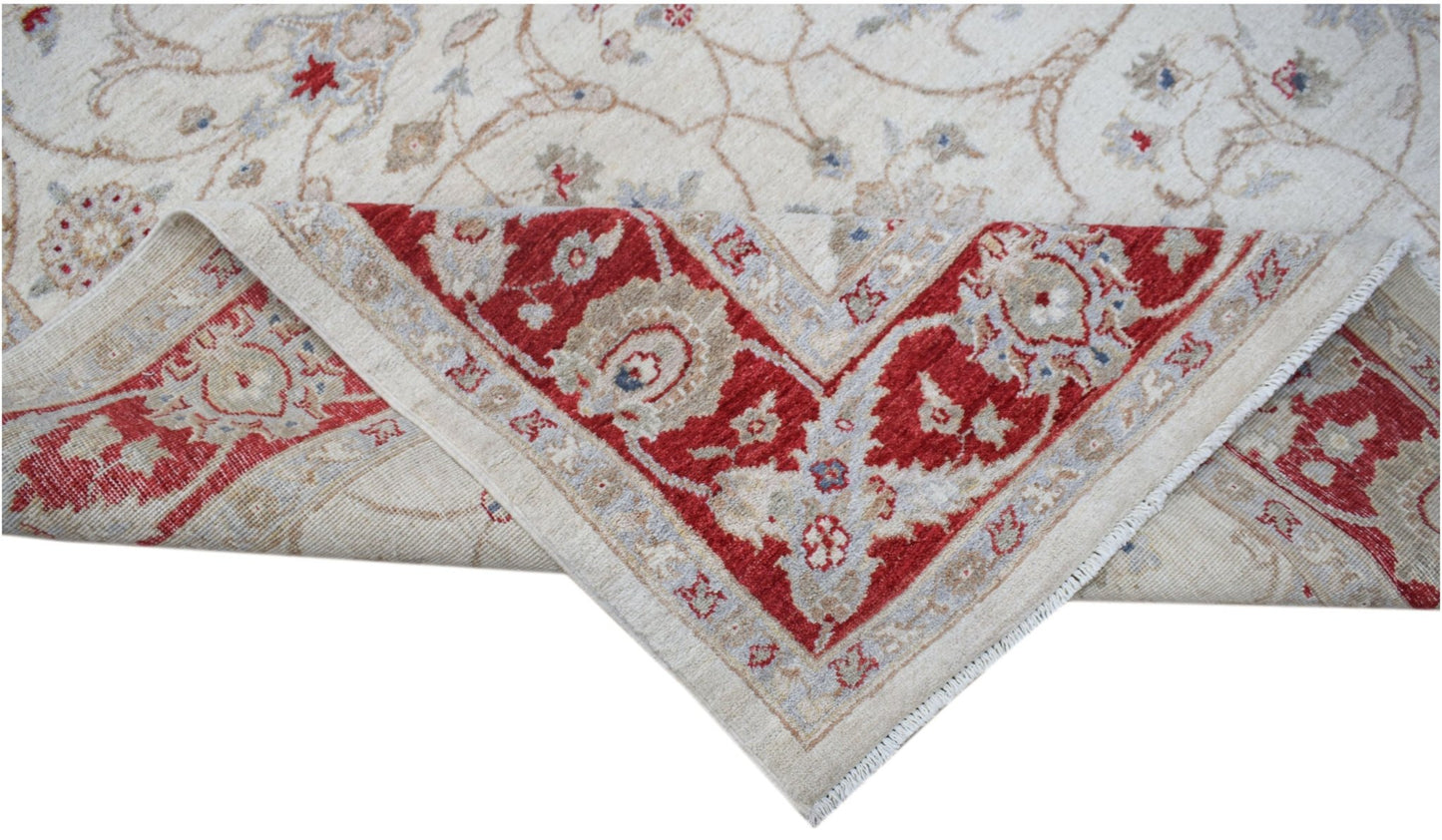 A handwoven Afghan Chobi rug featuring a cream field with red floral borders and intricate patterns.