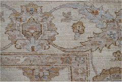 A close-up of a handwoven Afghan Chobi rug featuring traditional floral patterns in earthy tones.