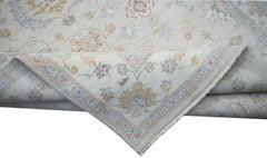 A handwoven Afghan Chobi rug featuring a traditional floral pattern in soft, muted earth tones.