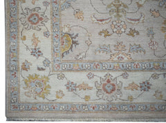 A handmade Afghan Chobi rug featuring a traditional floral pattern in soft, earthy tones.
