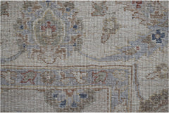 A close-up of a handwoven Afghan Chobi rug featuring traditional floral patterns in earthy tones.