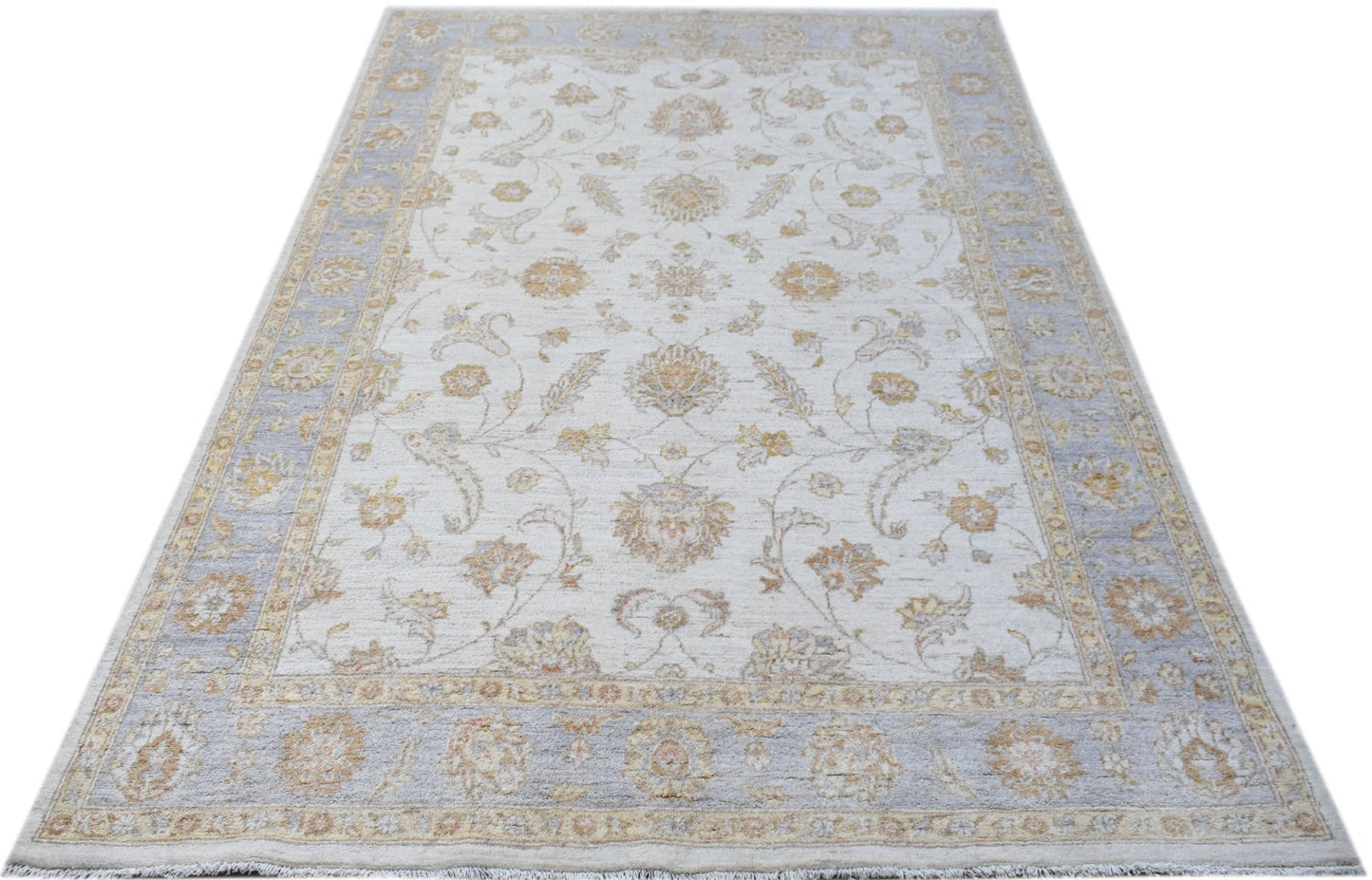 An Afghan Chobi rug featuring a traditional floral pattern in soft beige and blue tones.