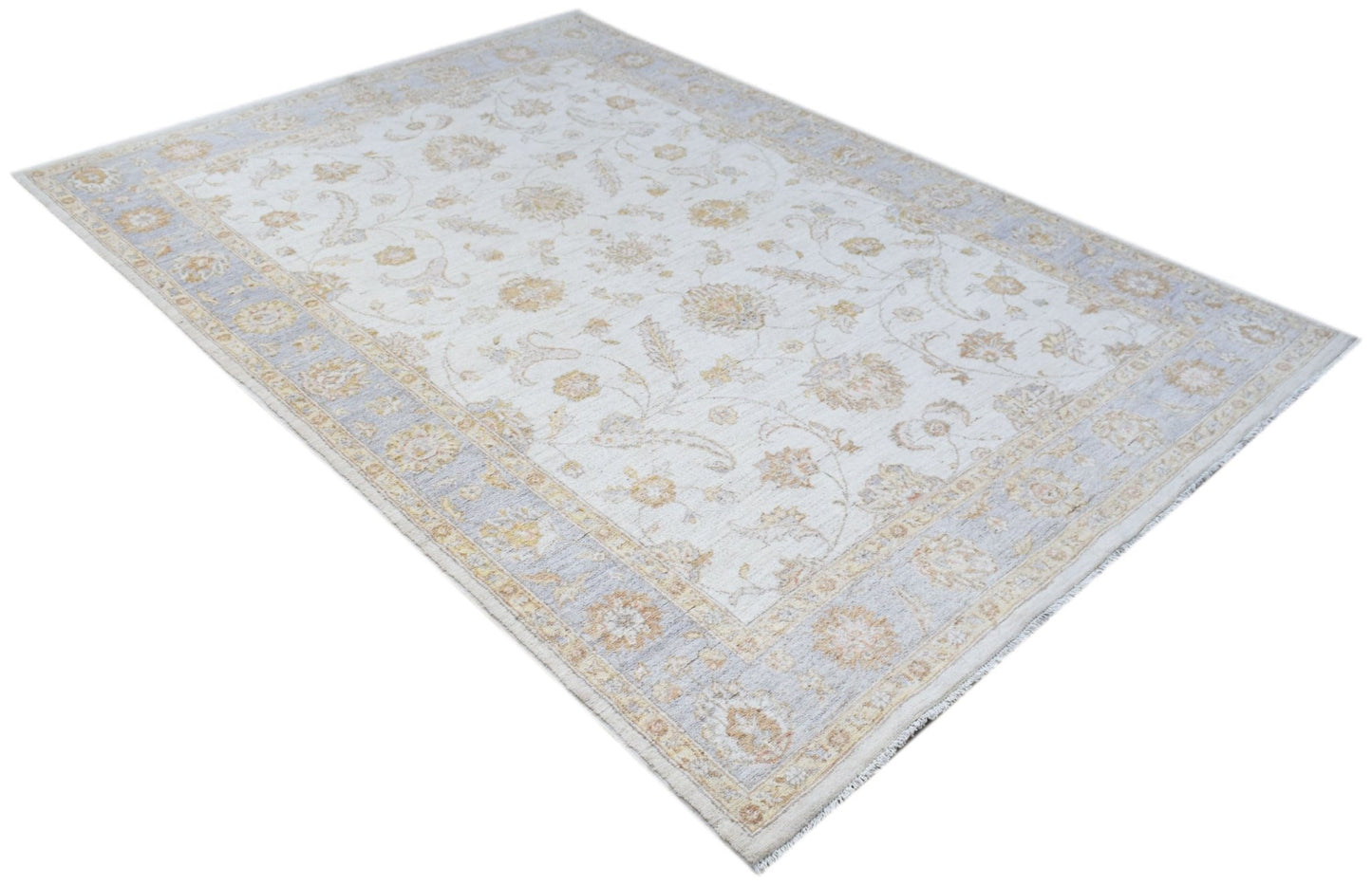 An Afghan Chobi rug featuring a traditional floral pattern in soft beige and light blue tones.