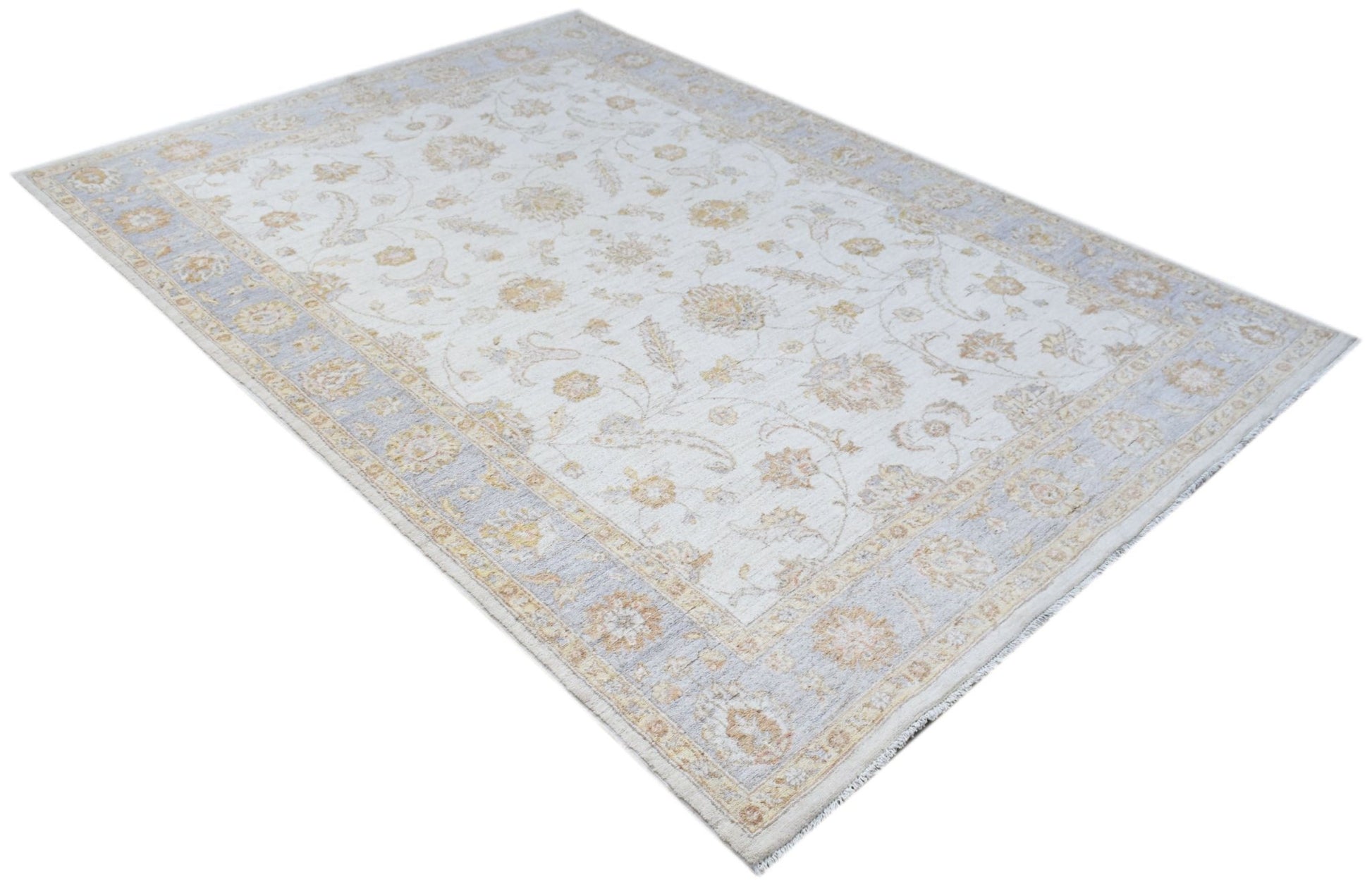 An Afghan Chobi rug featuring a traditional floral pattern in soft beige and light blue tones.