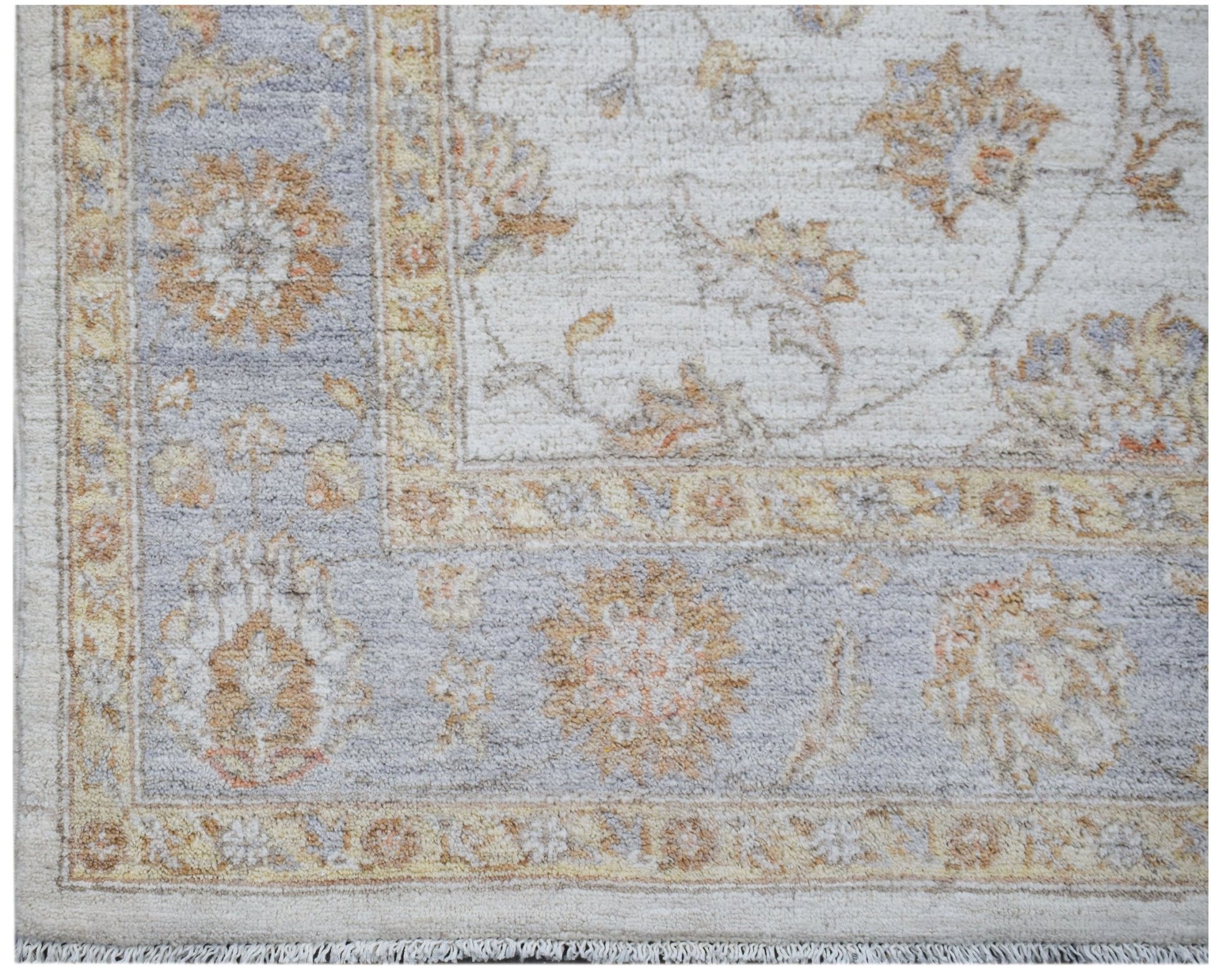 A handmade Afghan Chobi rug featuring a traditional floral pattern in soft beige and blue tones.