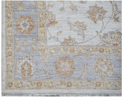 A handmade Afghan Chobi rug featuring a traditional floral pattern in soft beige and blue tones.