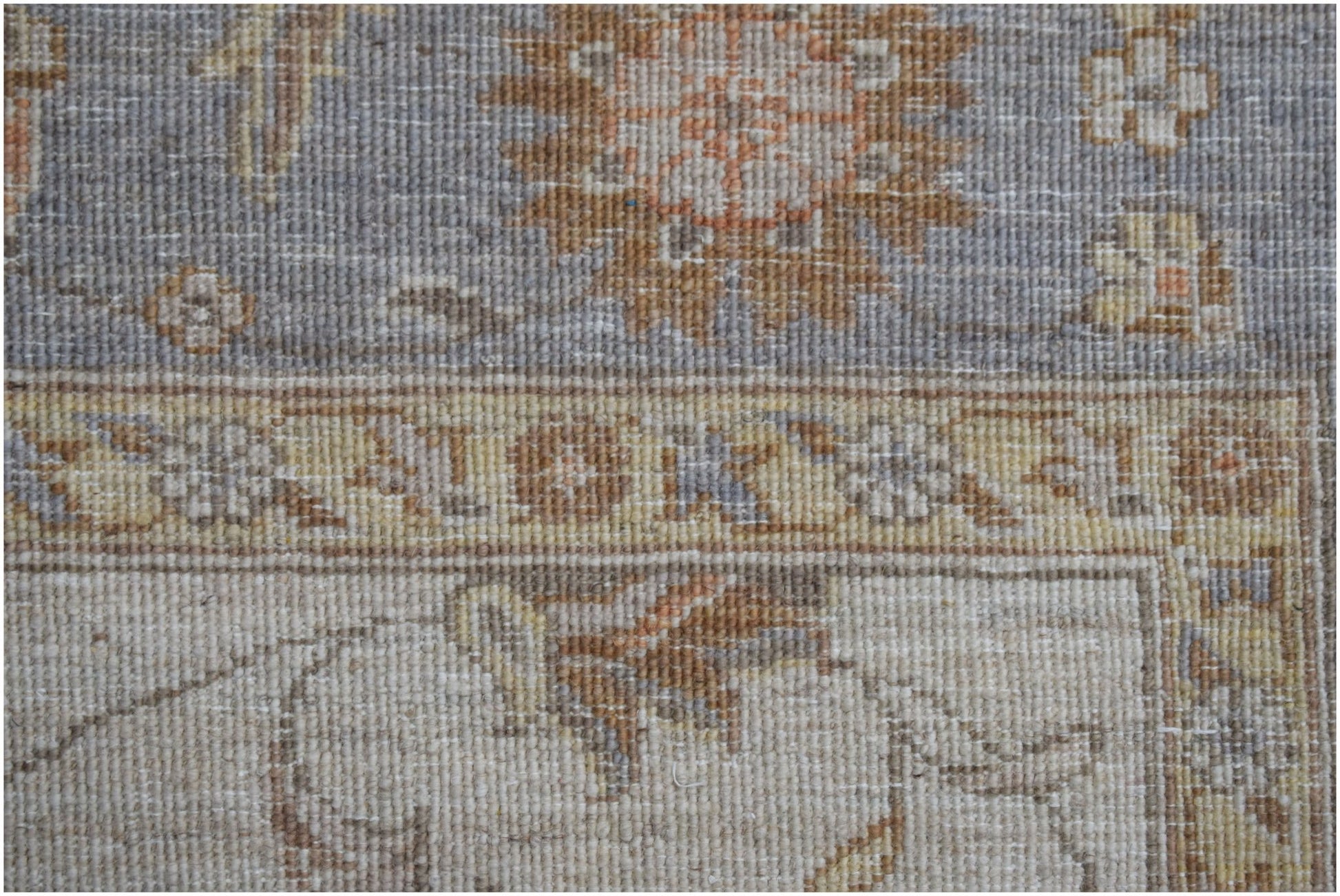 A close-up of an Afghan Chobi rug featuring traditional floral patterns in muted earth tones.