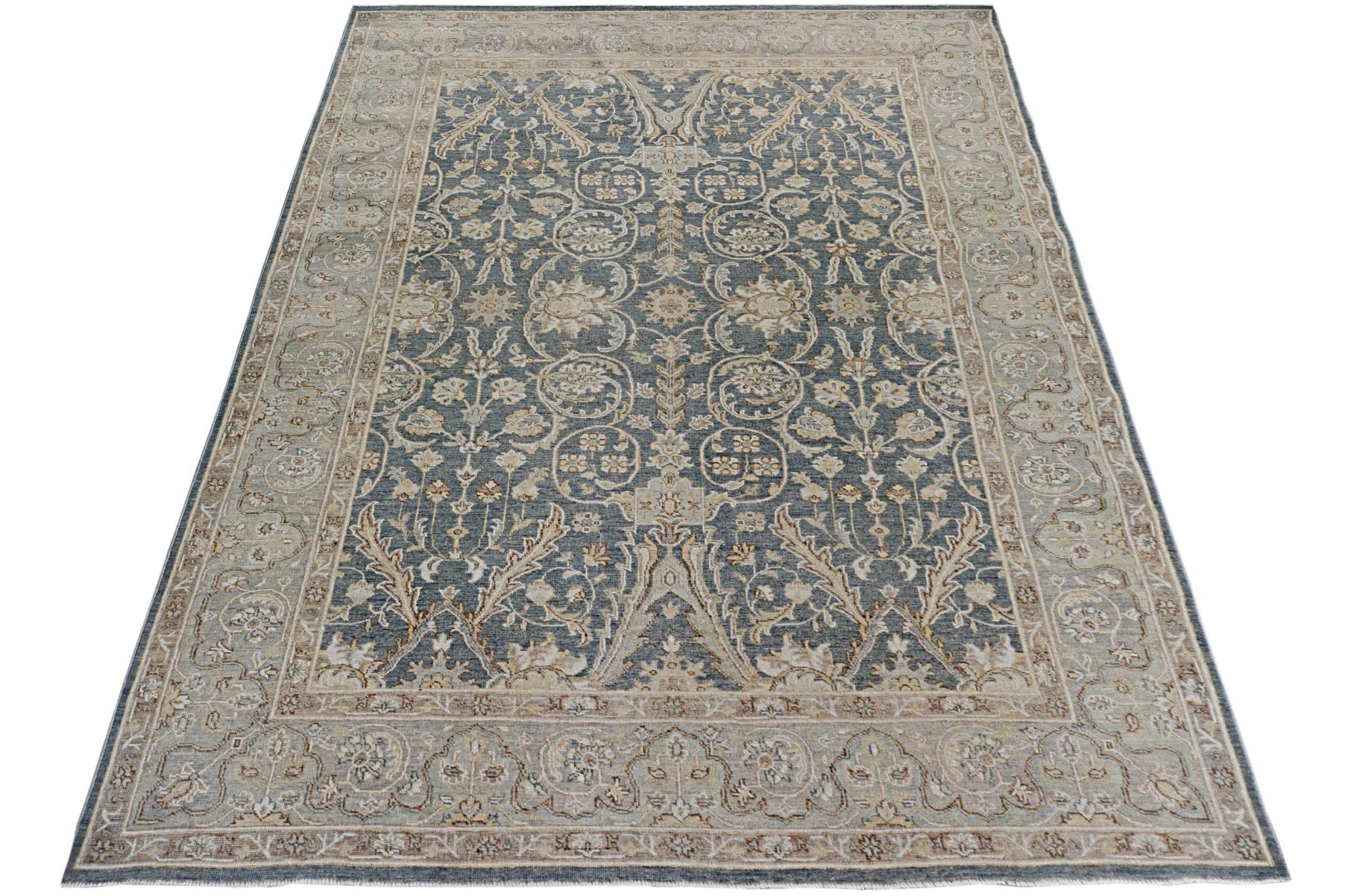A handmade Afghan Chobi rug featuring a traditional floral pattern in blue and beige tones.