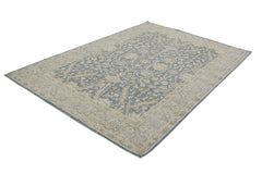 A rectangular Afghan Chobi rug featuring a traditional floral pattern in blue and beige tones.