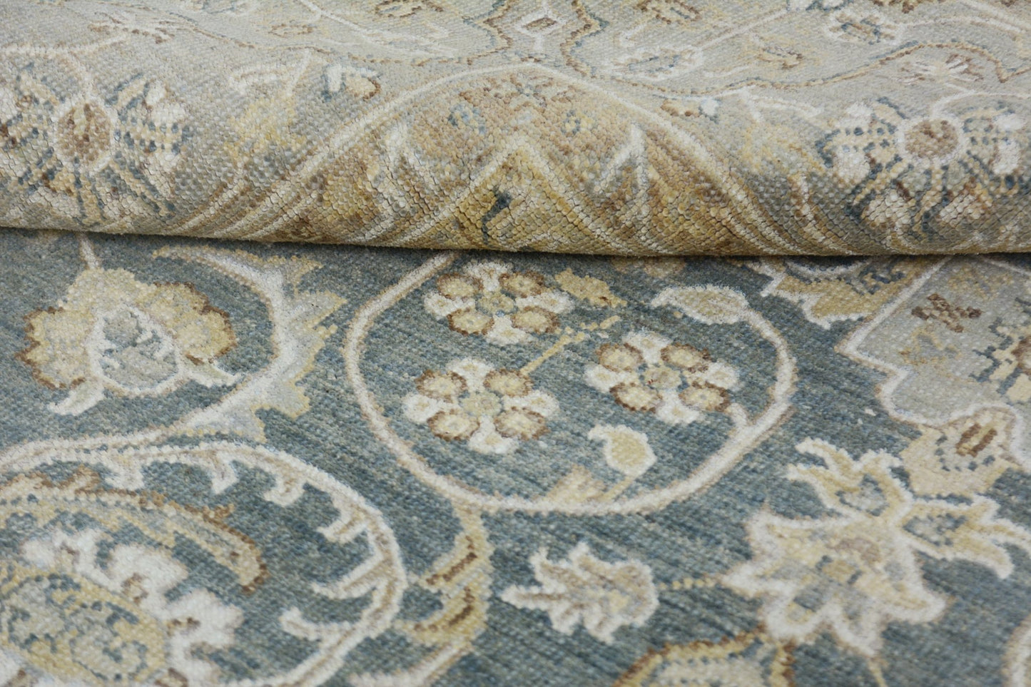 A handmade Afghan Chobi rug featuring a traditional floral pattern in blue and beige tones.