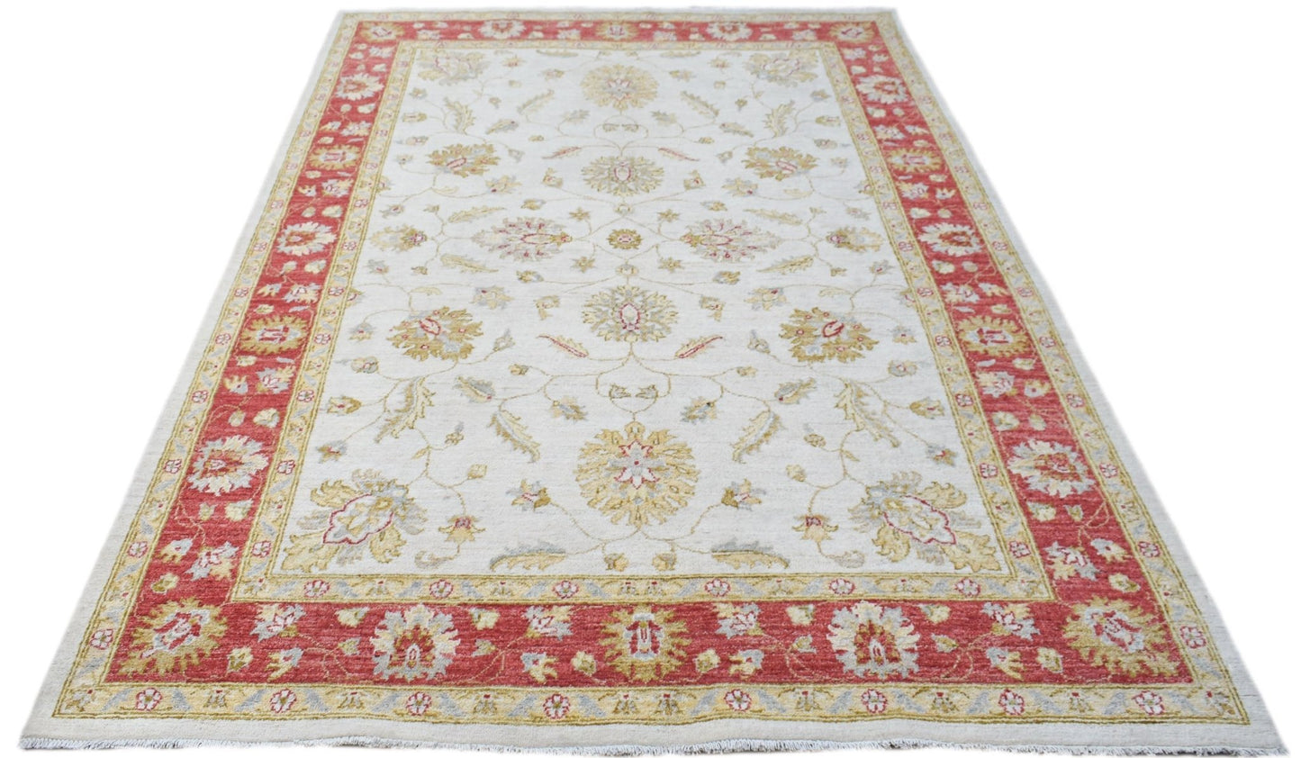 An Afghan Chobi rug featuring a cream field with floral patterns and a wide red border.