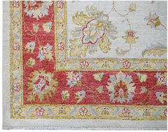A handwoven Afghan Chobi rug featuring a floral pattern in red, cream, and gold tones.