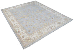 A rectangular Afghan Chobi rug featuring a light blue field with floral patterns and a cream border.