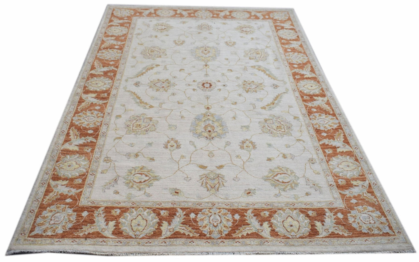 An Afghan Chobi rug featuring a traditional floral pattern in soft orange and cream tones.