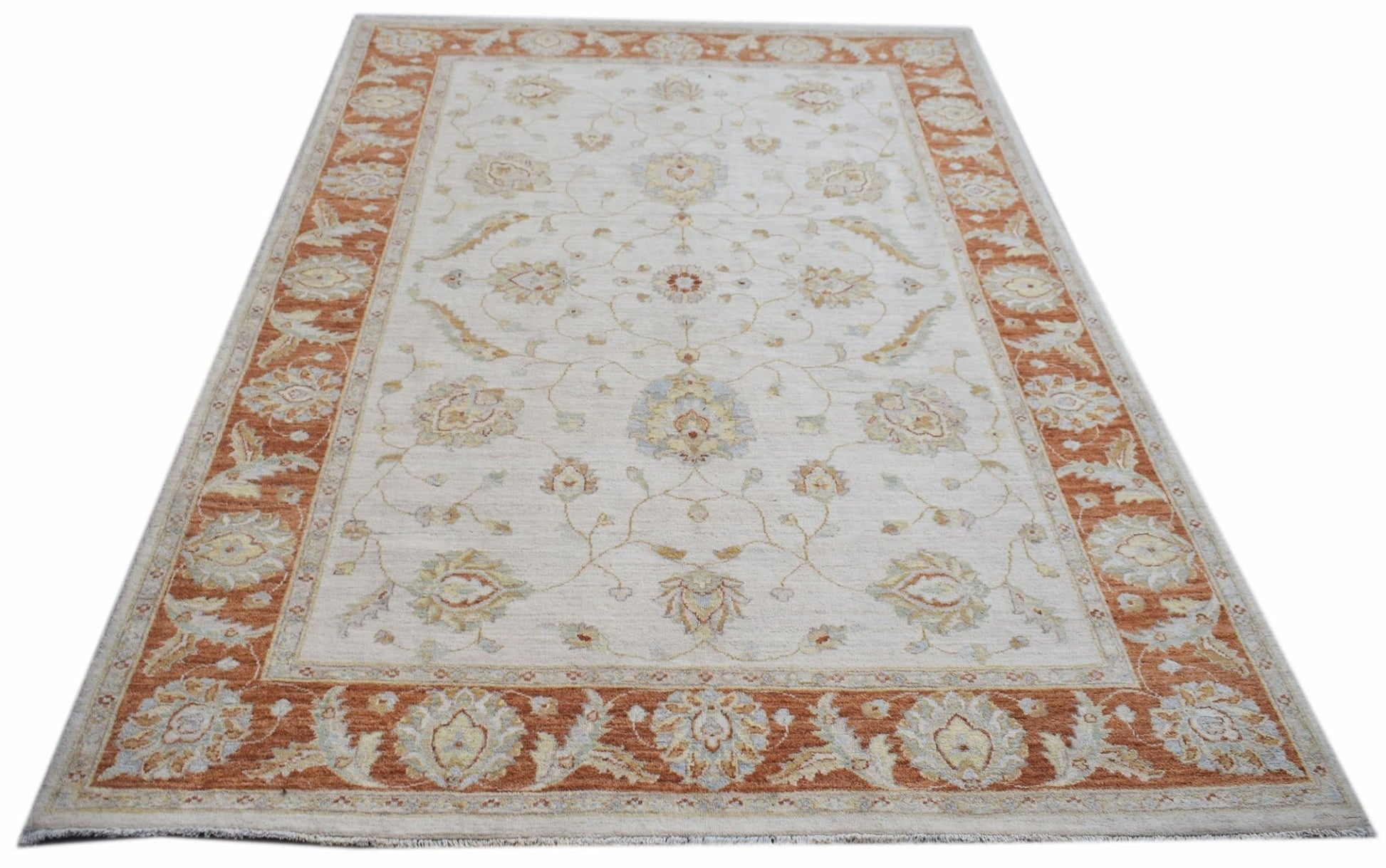 An Afghan Chobi rug featuring a traditional floral pattern in soft orange and cream tones.