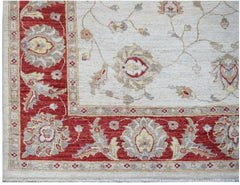A handwoven Afghan Chobi rug featuring a traditional floral pattern in red, cream, and beige tones.