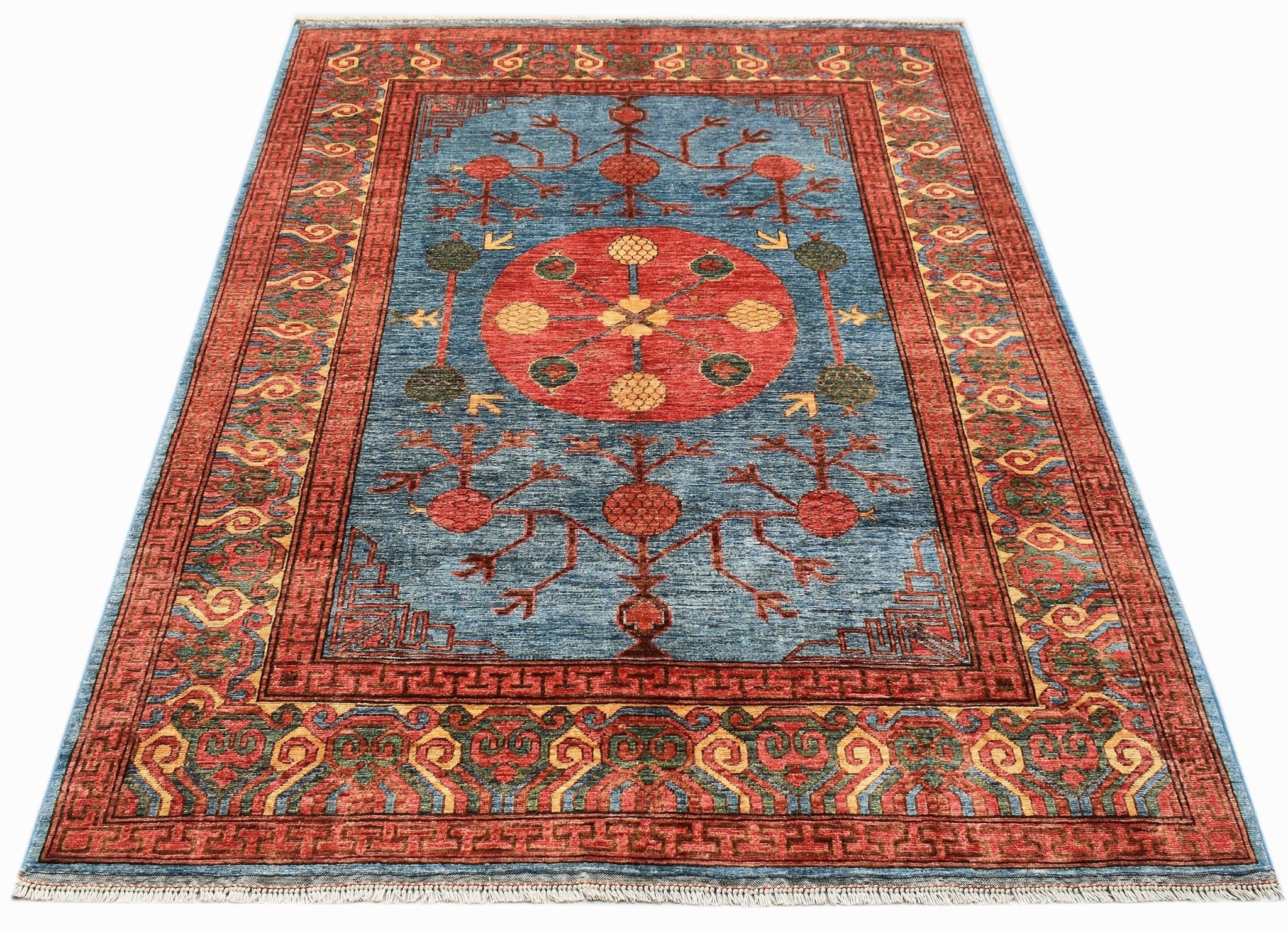 A rectangular Afghan Chobi rug featuring a blue field with a central red medallion and floral motifs.