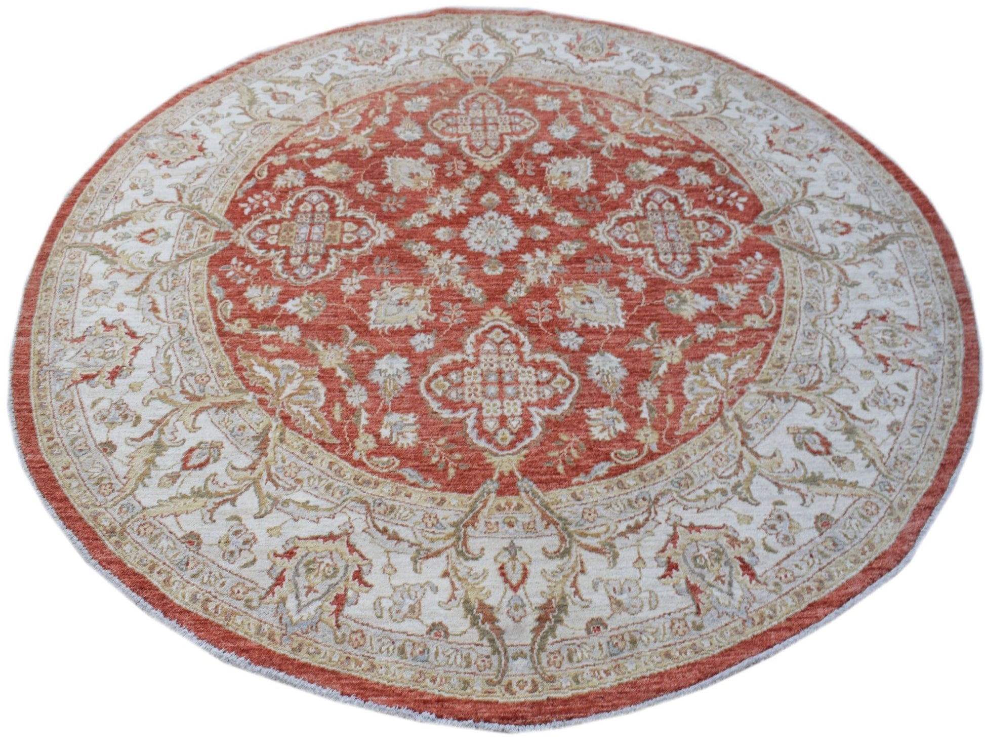 A round Afghan Chobi rug featuring a traditional floral pattern in shades of terracotta and cream.