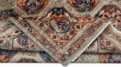 A handwoven Afghan Chobi rug featuring geometric patterns in earthy tones on a light background.