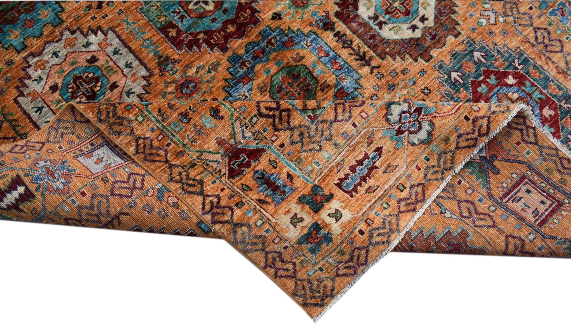 A handwoven Afghan Chobi rug featuring a traditional geometric pattern in warm orange and blue tones.