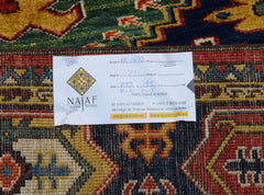 A handmade Afghan Chobi rug featuring a traditional geometric pattern in rich, earthy tones.