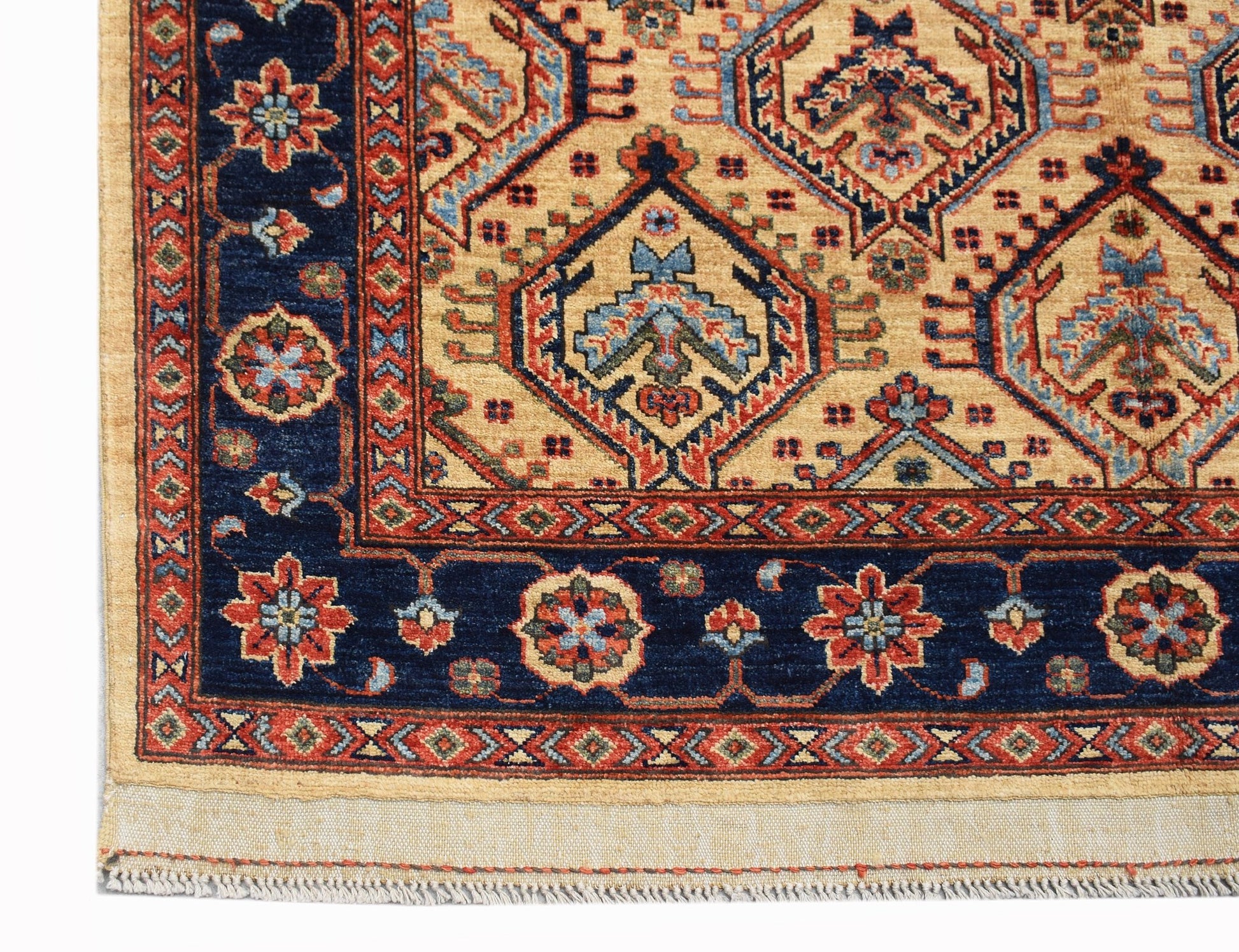 A handmade Afghan Chobi rug featuring a geometric pattern in blue, red, and beige tones.