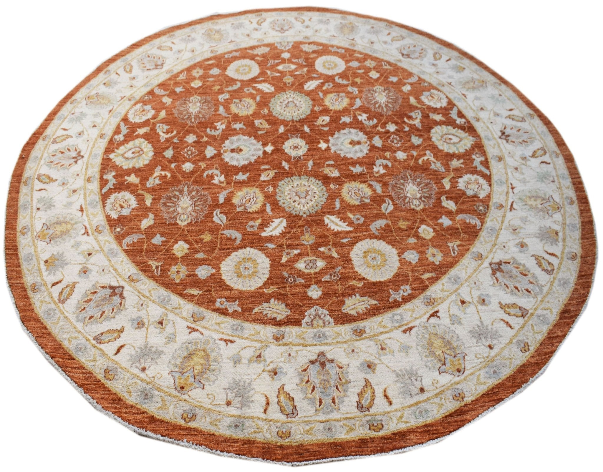 A round, handwoven Afghan Chobi rug featuring a traditional floral pattern in rust and cream tones.