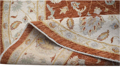 A handwoven Afghan Chobi rug featuring a traditional floral pattern in rust and cream tones.