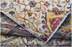 A folded Afghan Chobi rug featuring intricate floral patterns in warm earth tones and blue accents.