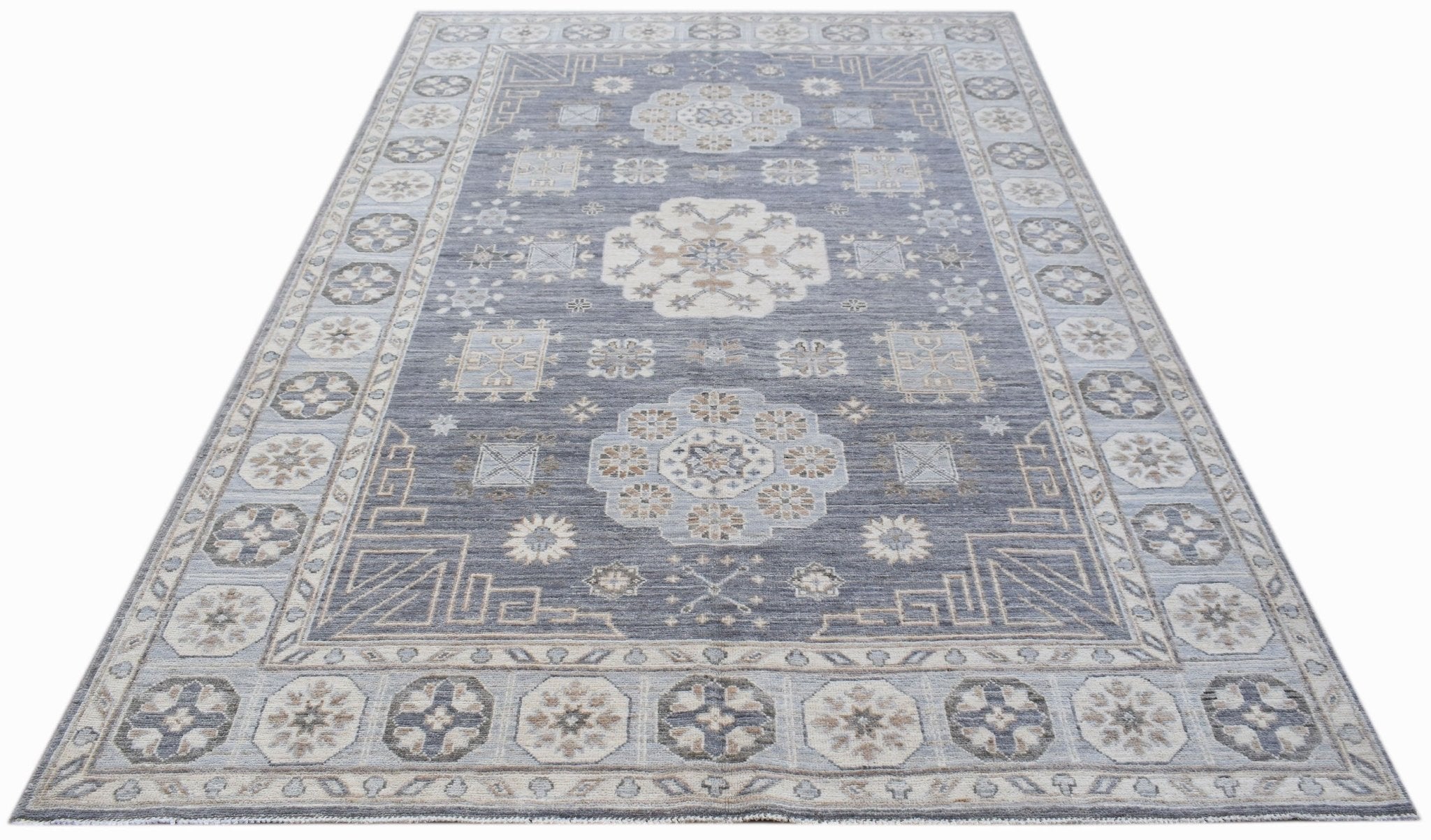 A rectangular Afghan Chobi rug featuring a traditional floral pattern in shades of blue and beige.