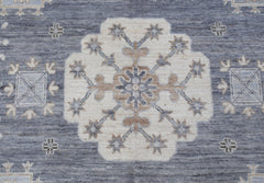 A handmade Afghan Chobi rug featuring a central floral medallion on a textured blue background.
